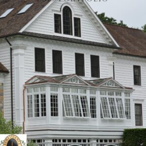 A white house with a large window and a porch.