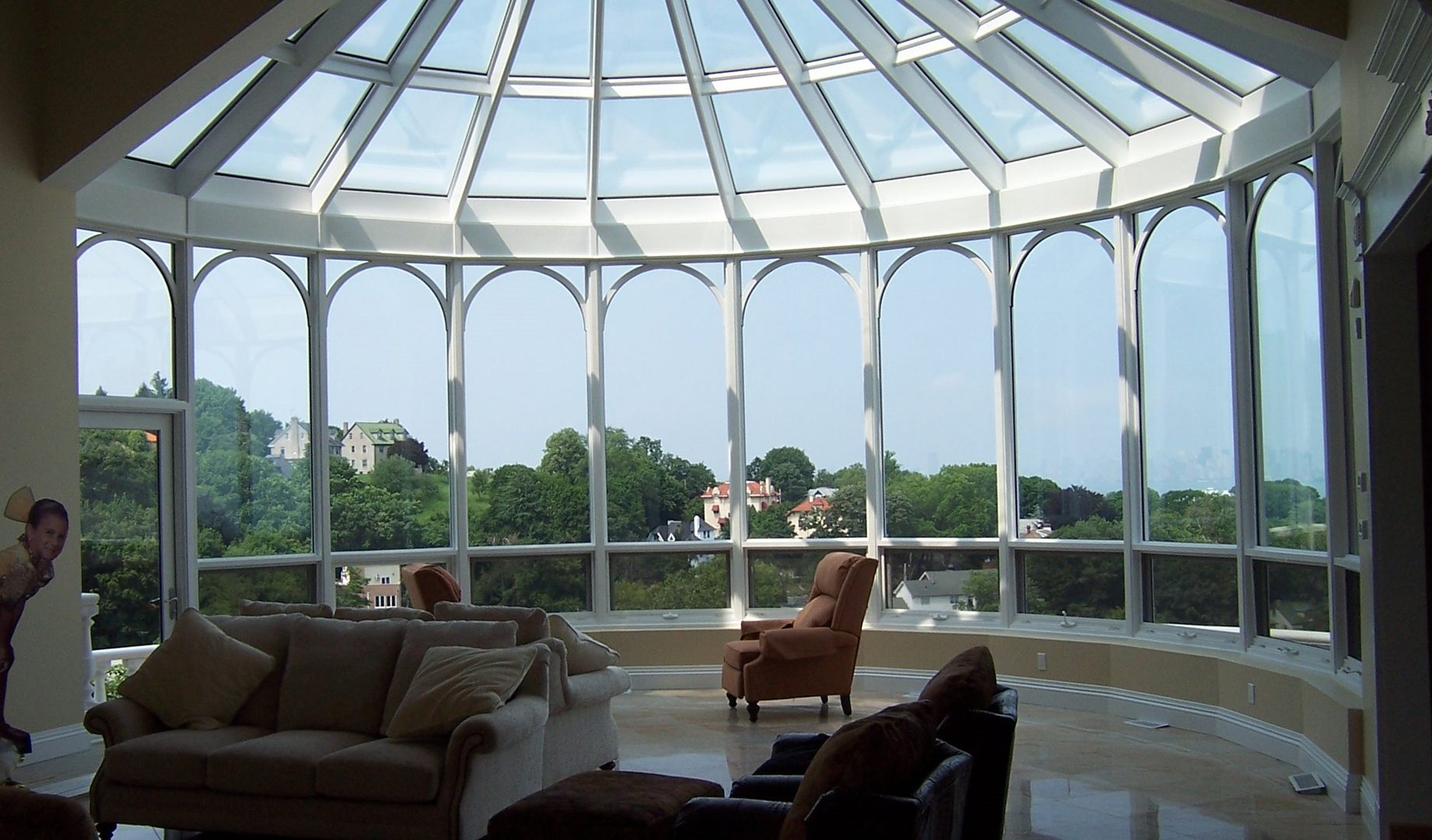 A room with many windows and furniture in it