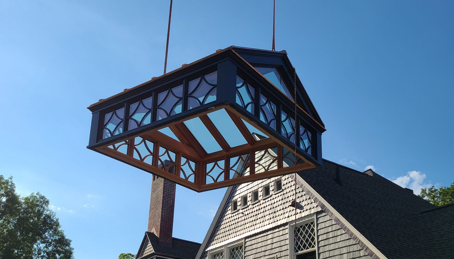 A large wooden structure hanging from the side of a building.