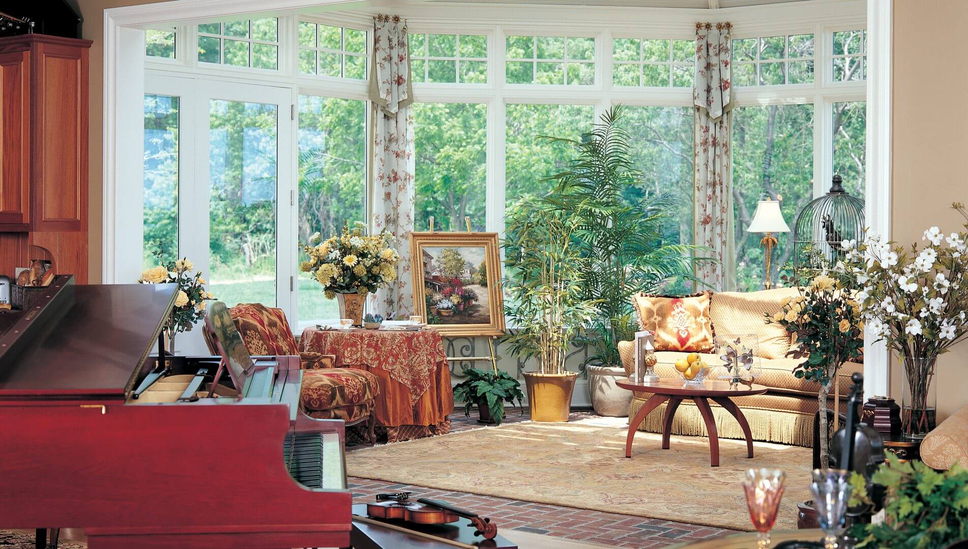 A living room with many windows and furniture.