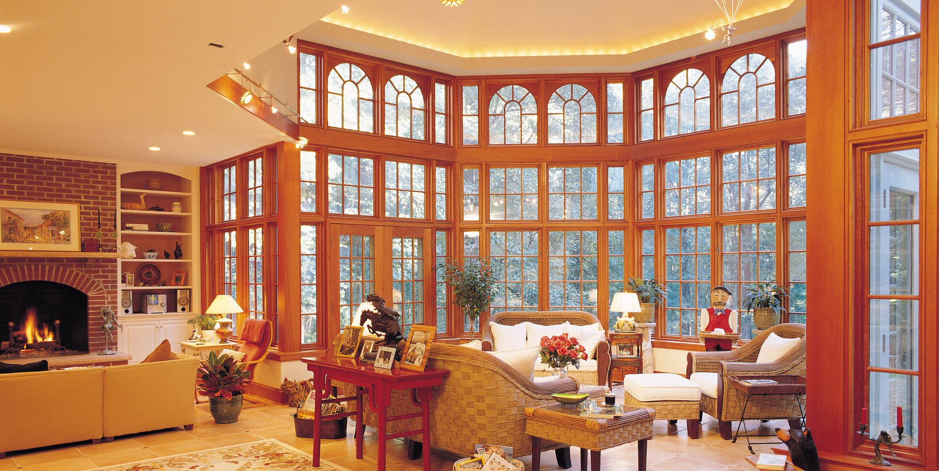A living room with many windows and furniture
