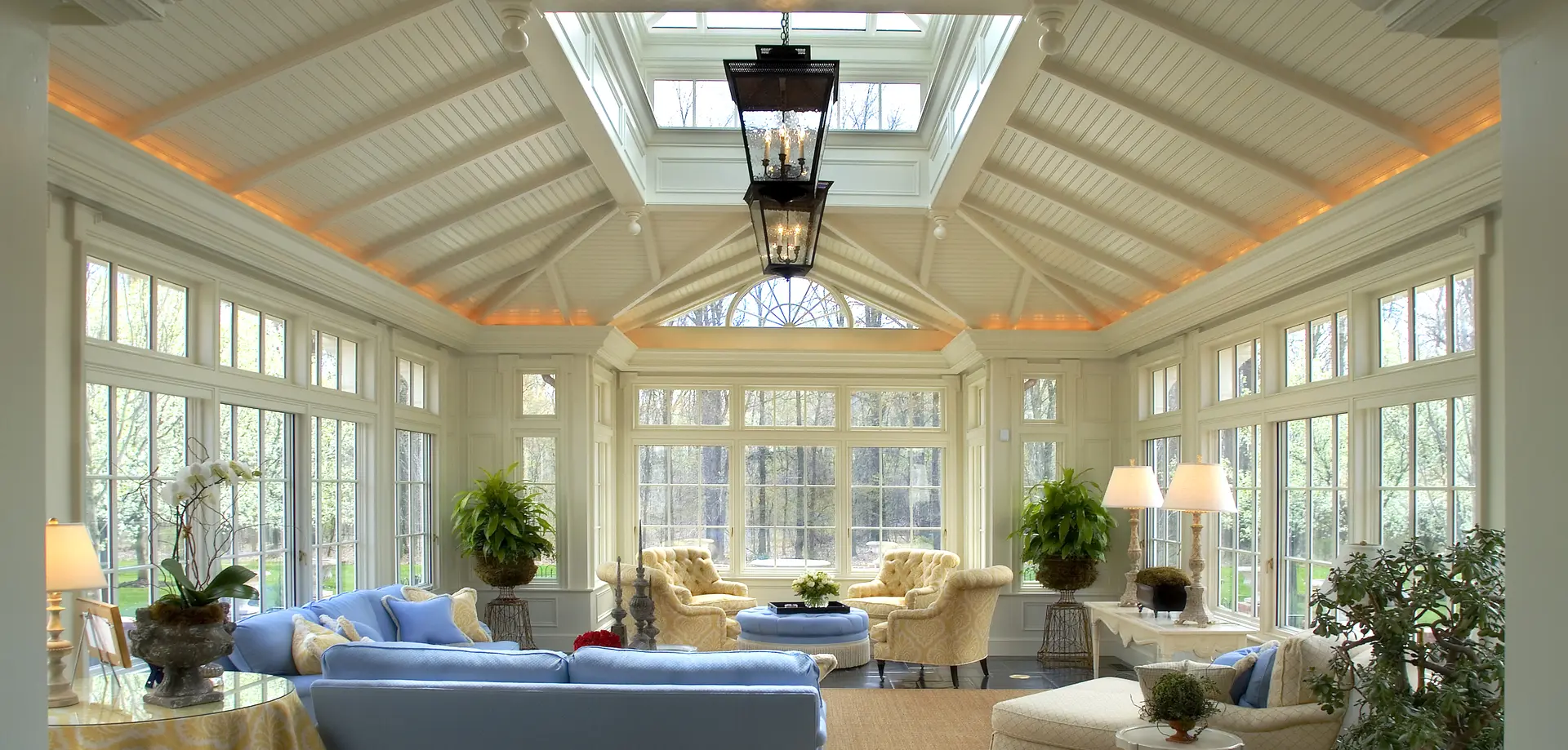 A living room with two large windows and a skylight.