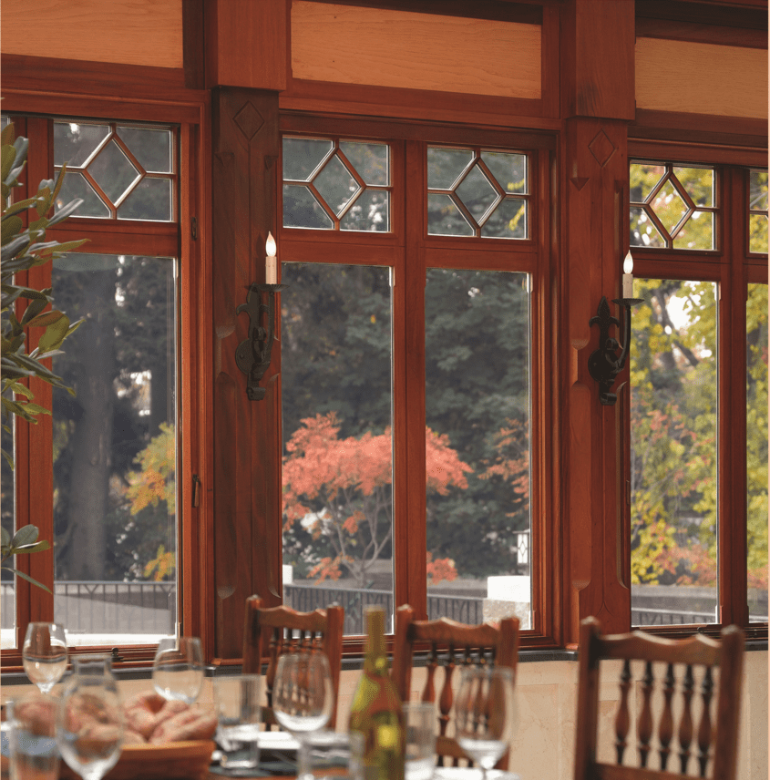 A dining room with wooden chairs and tables.