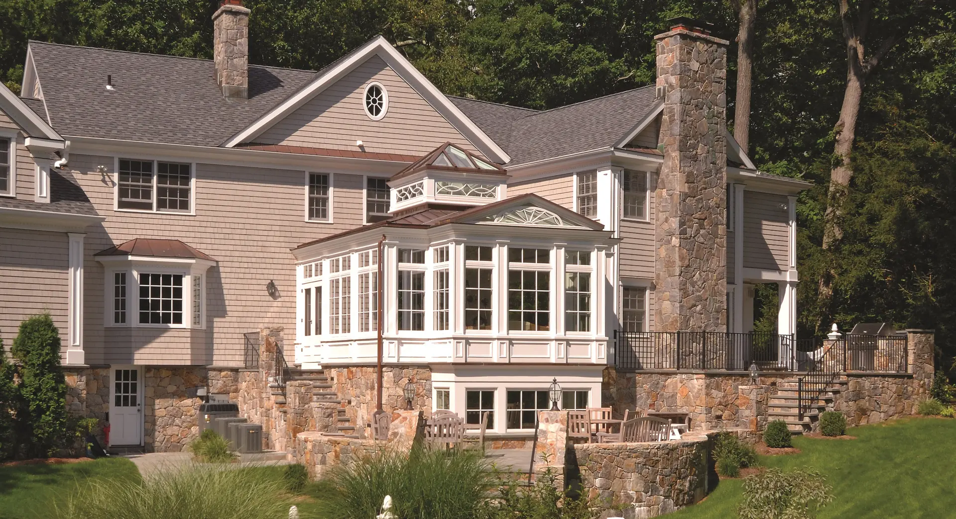 A large house with a lot of windows and stone