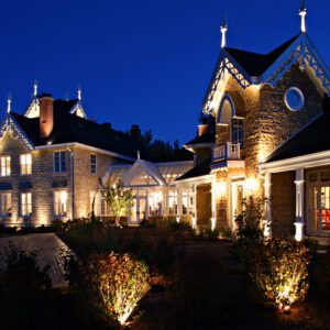 A large house with many lights on the outside.