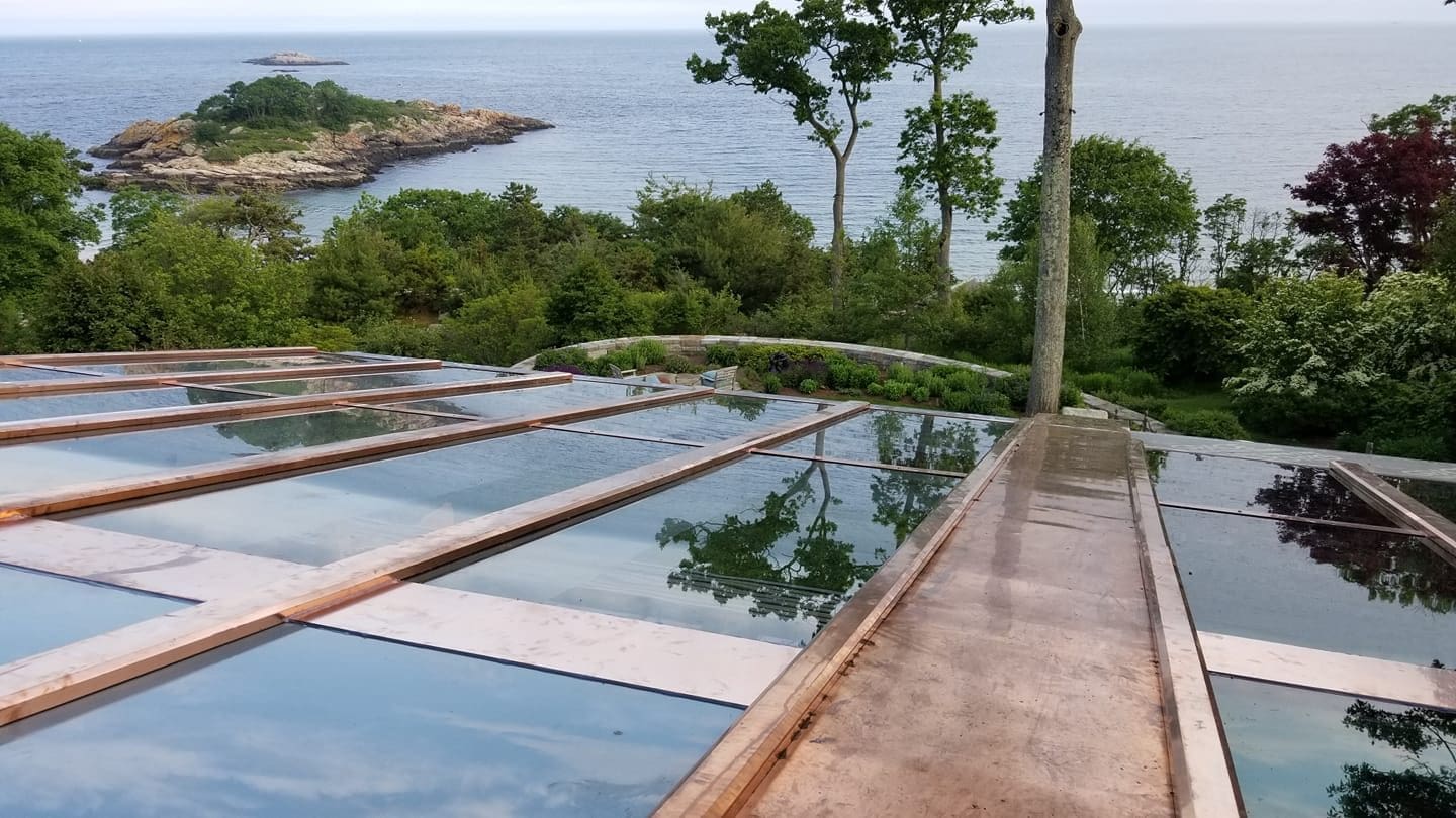 A view of the ocean from above a pool.