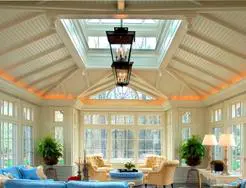 A living room with a large skylight and many windows.