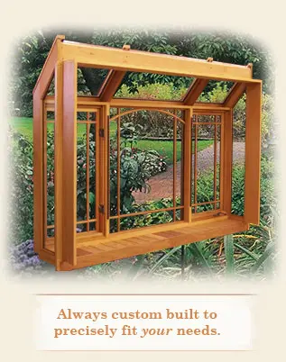 A wooden structure with glass windows and a garden.