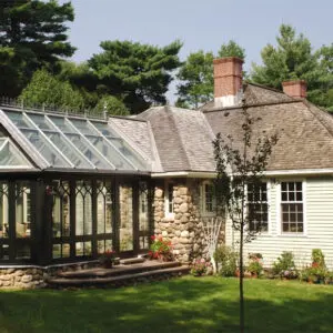 A house with a large glass roof and brick wall.