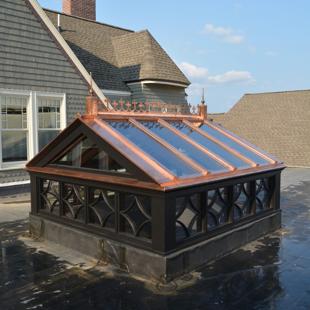 A roof with copper panels and a black frame.