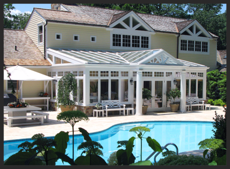 A large pool with a house in the background.