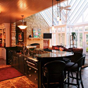 A kitchen with a large island and a fireplace.