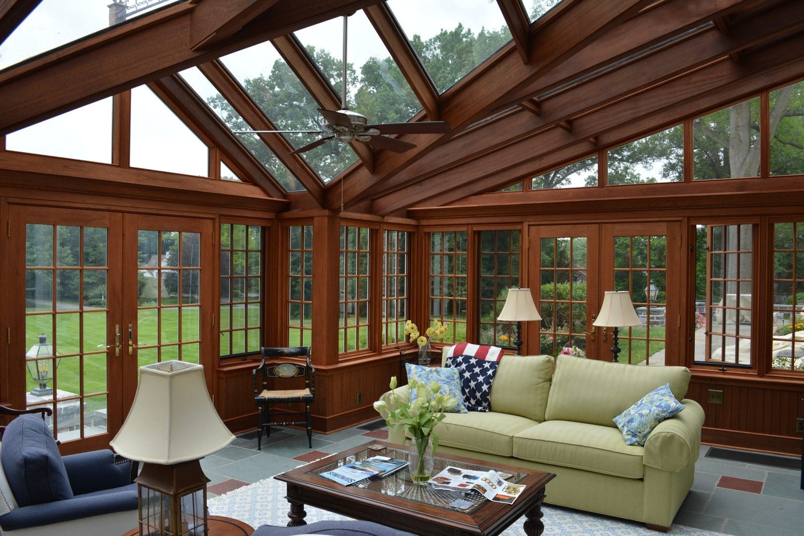 A living room with many windows and furniture
