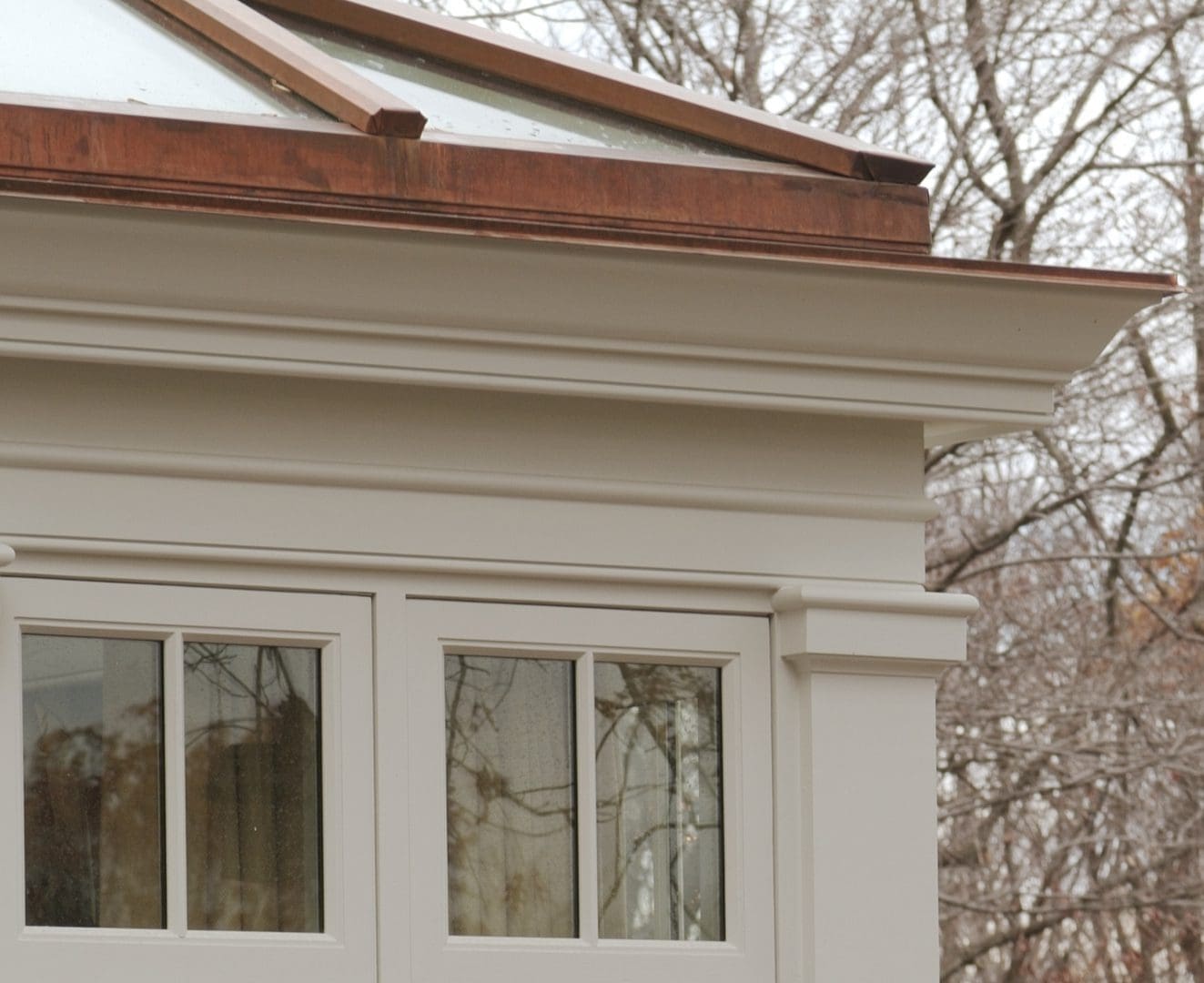 A close up of the window and roof on a house