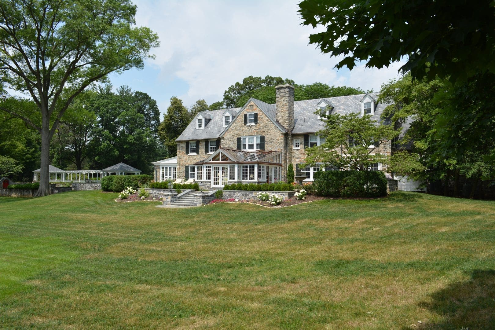 A large house with trees in the background