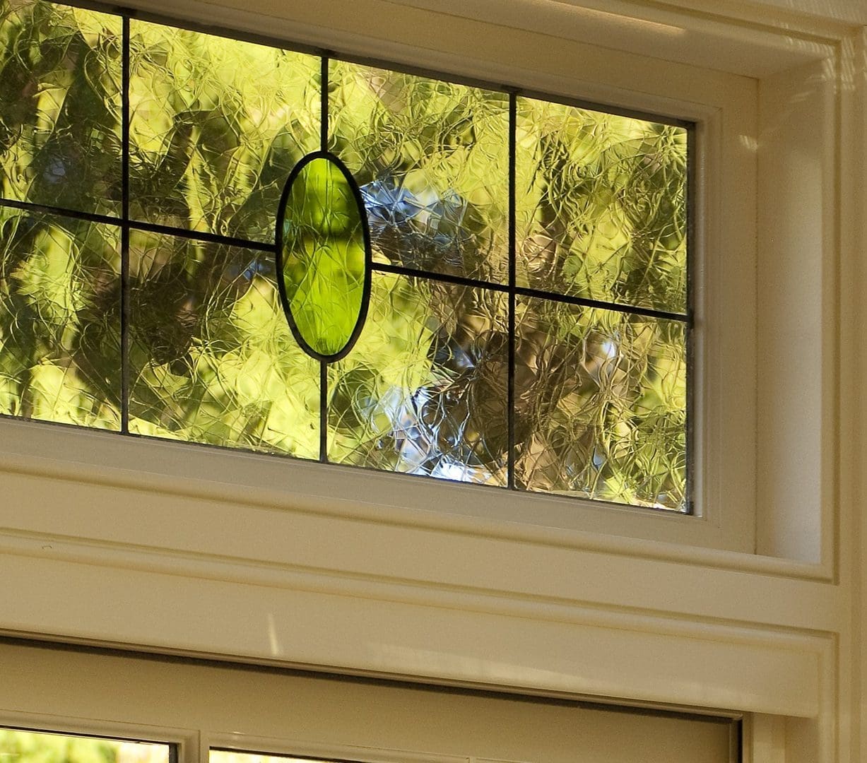 A window with green glass in the center of it.