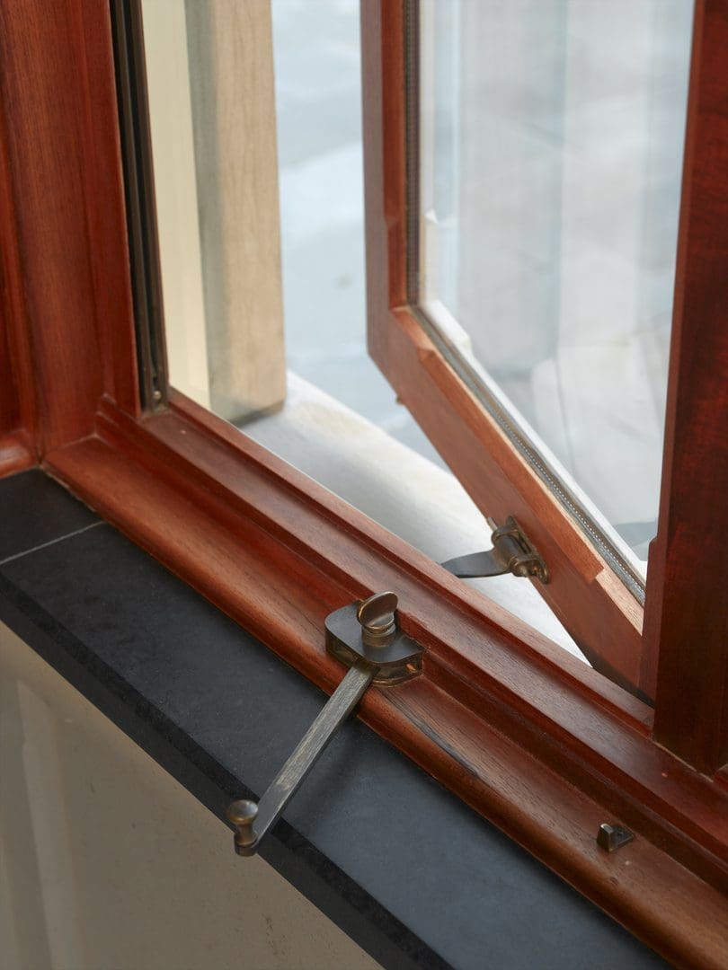 A window with some wooden trim and a glass pane