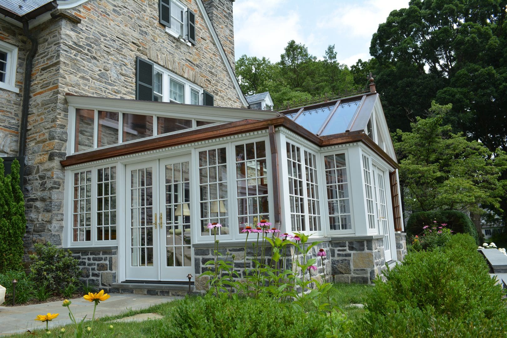 A large white house with a porch and windows.
