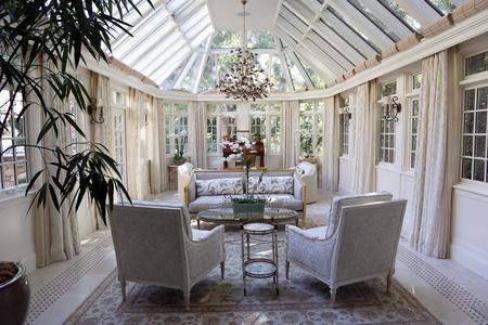 A living room with two white chairs and a table