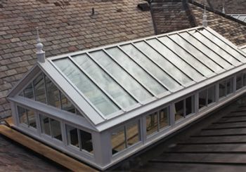 A roof with a glass top and a wooden floor