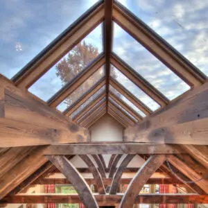 A wooden structure with multiple windows and a sky background