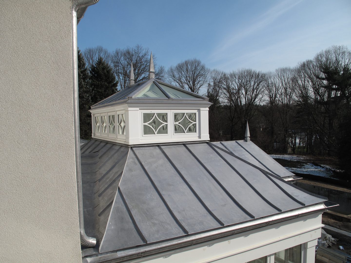 A roof with a cupola and a metal roof.