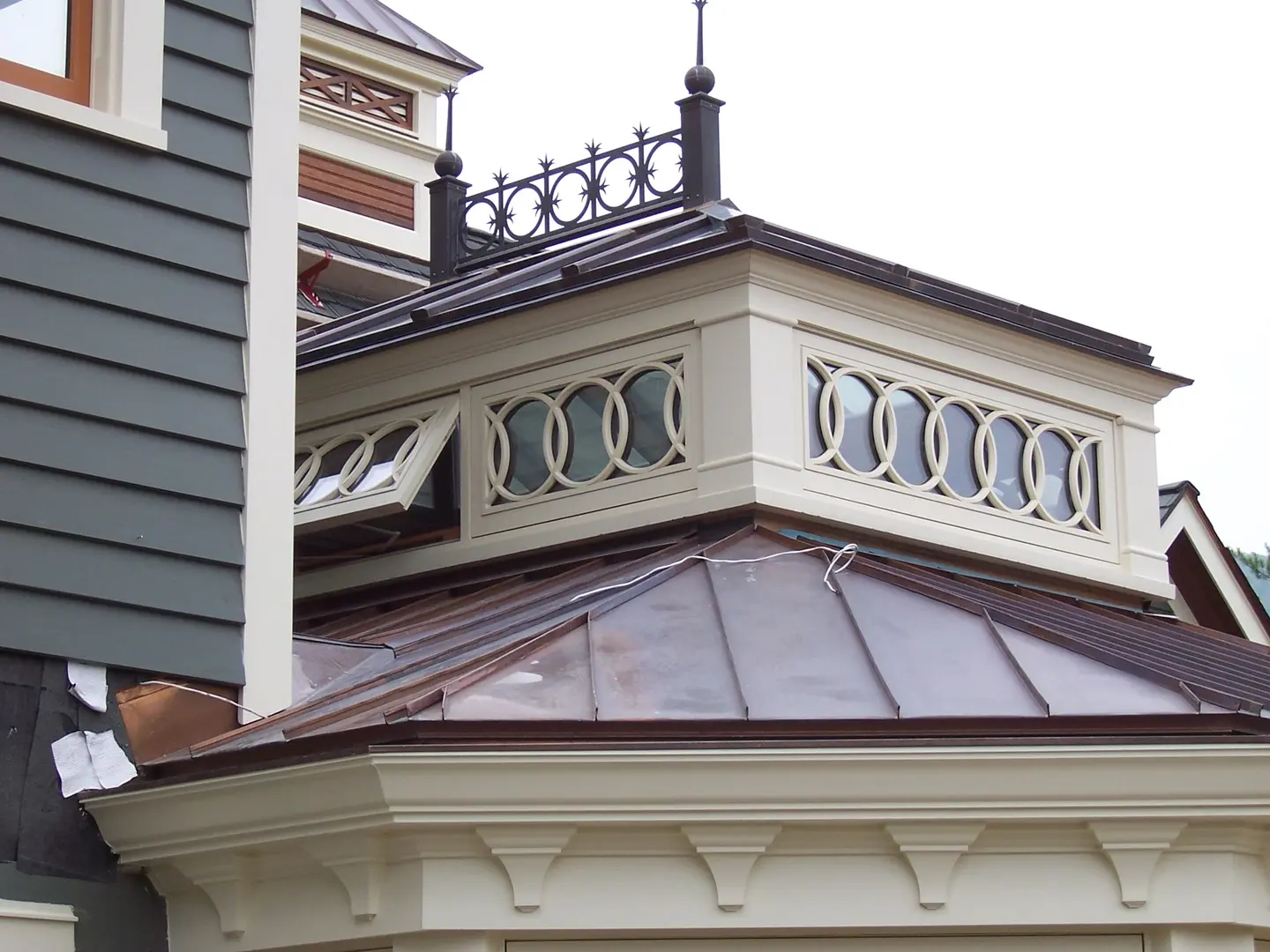 A close up of the corner of a building with a metal roof.
