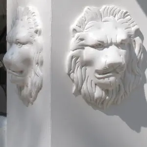 A white lion head on the side of a building.