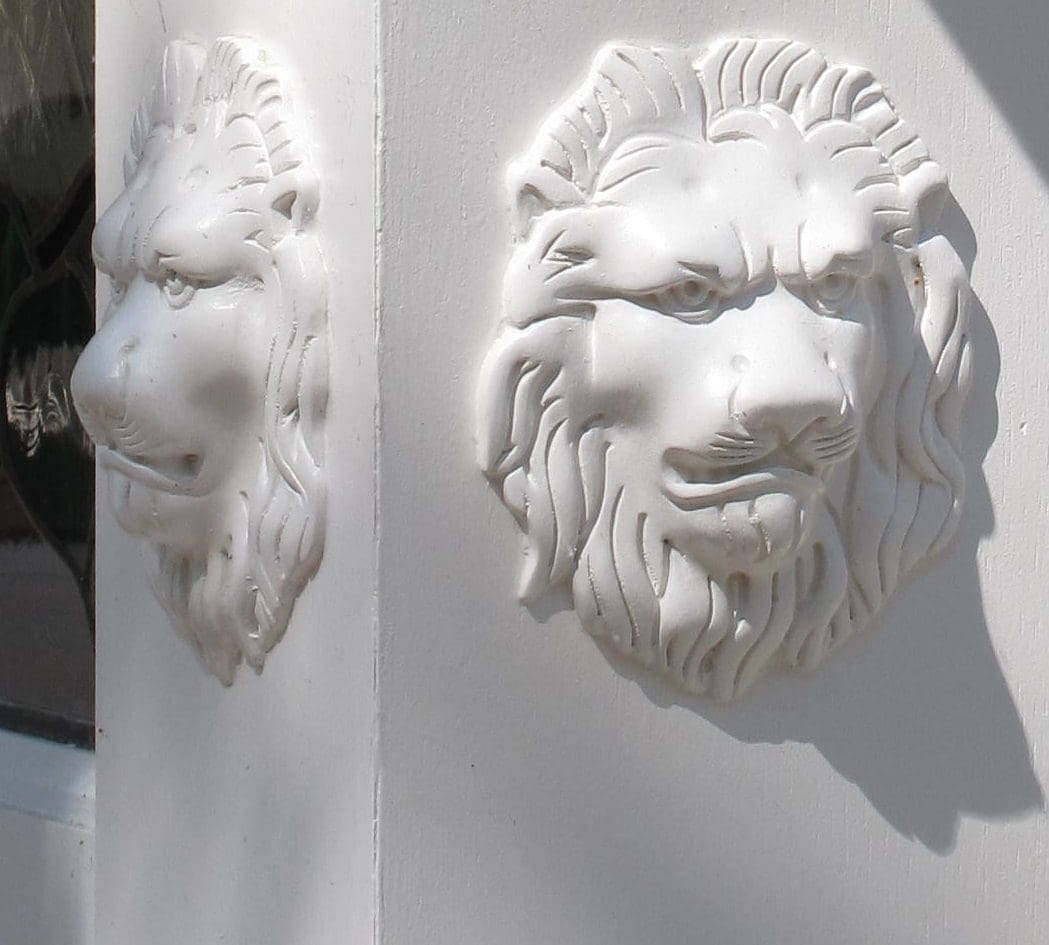 A white lion head on the side of a building.