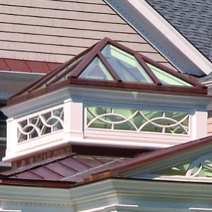 A close up of the top of a building with windows.