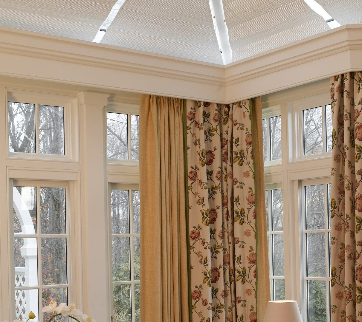 A room with many windows and curtains