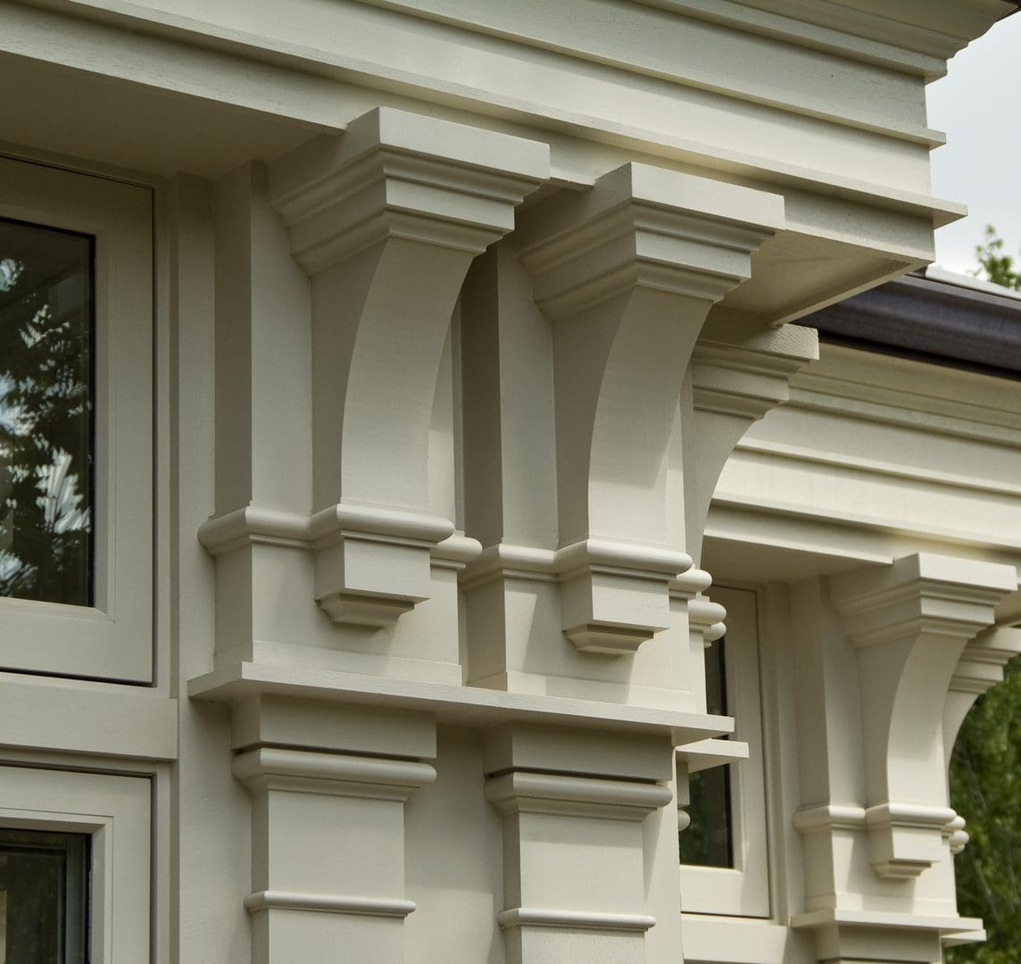A close up of the front of a building with columns.