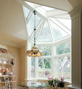A room with a large window and a chandelier.