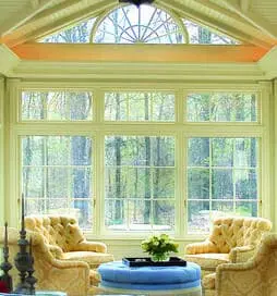 A room with two yellow chairs and a blue table