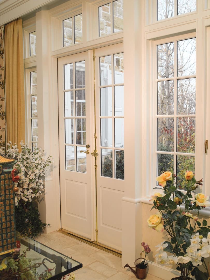 A room with two doors and many windows