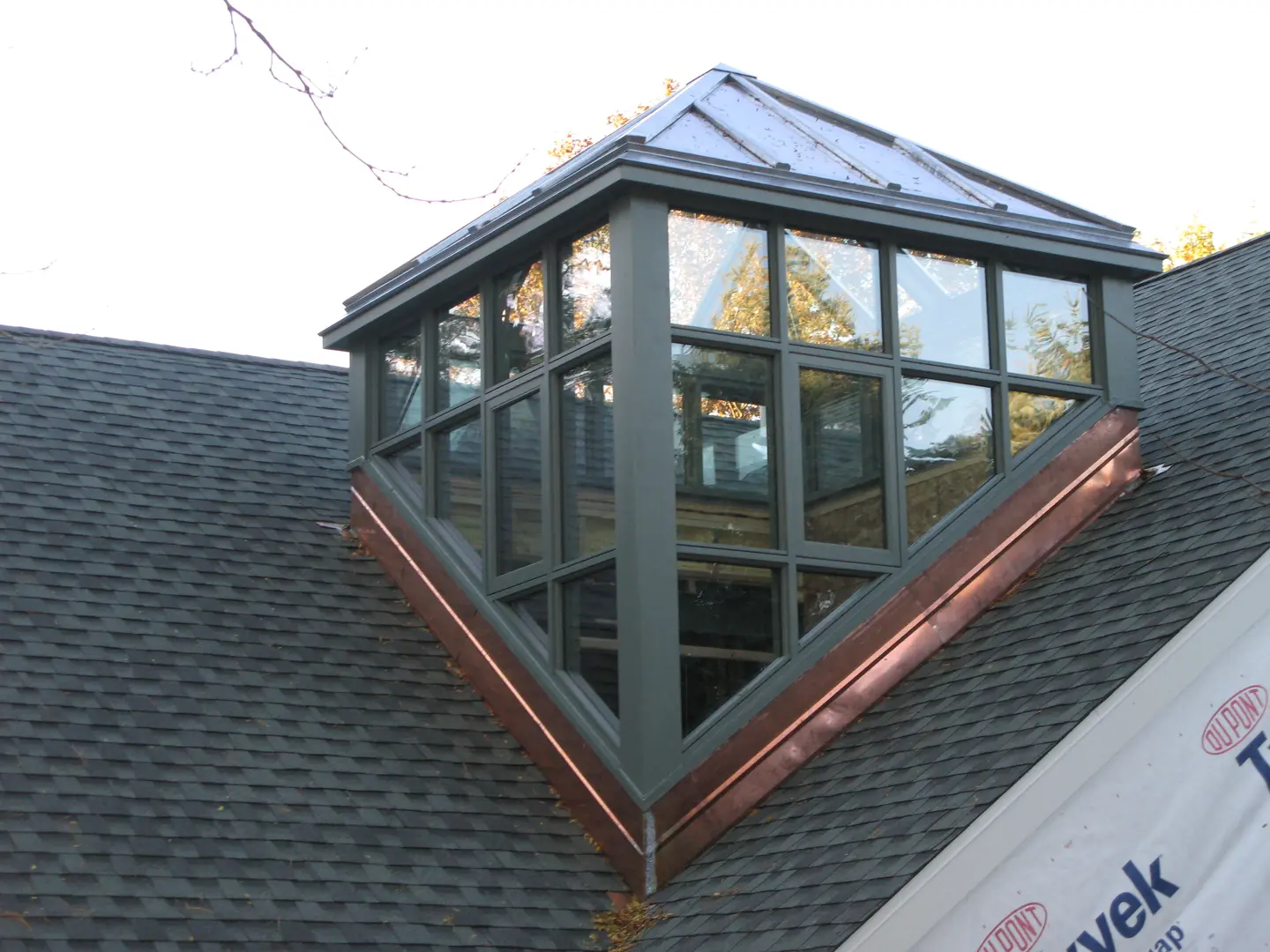 A roof with a glass window on top of it.
