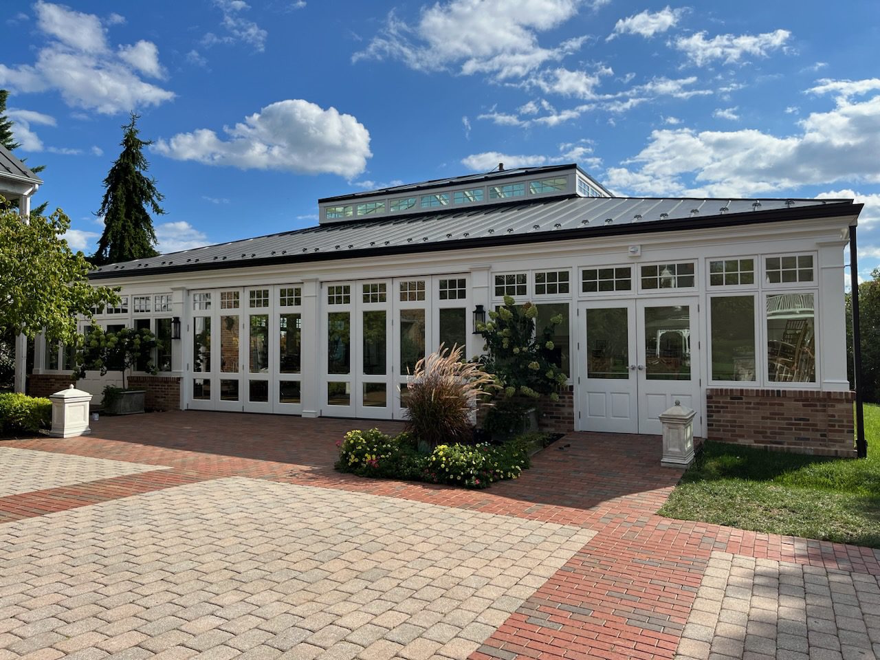 A large white building with brick floors and windows.