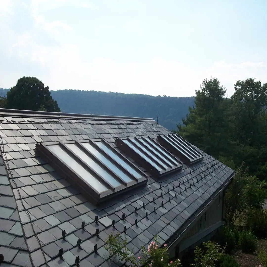 A roof with three solar panels on it.